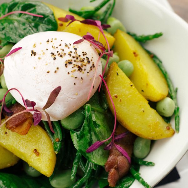 Summer salad with green and a poached egg main dish
